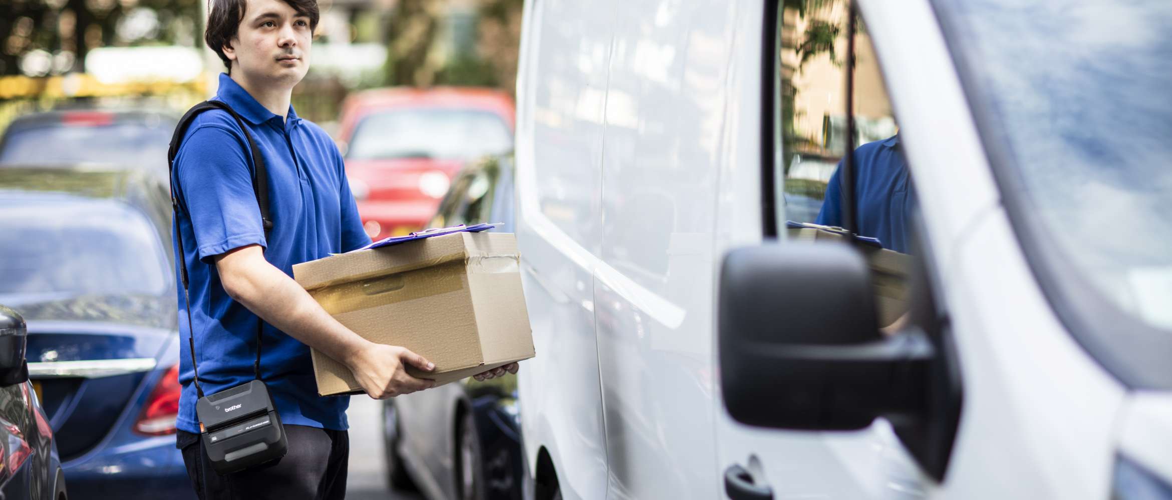 Kuljetusyrityksen työntekijä on toimittamassa pakettia asiakkaalle.